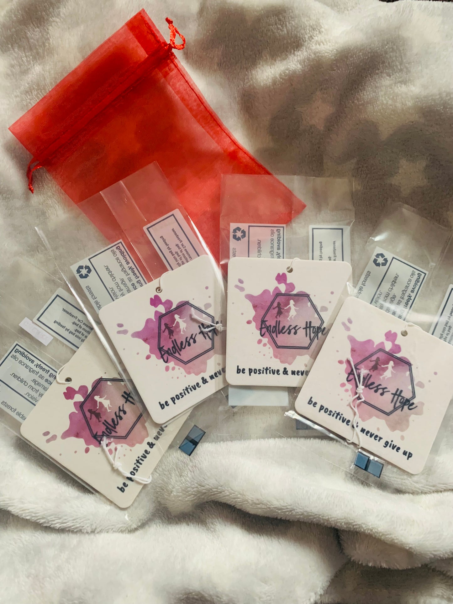 4 car/home double sided air fresheners, presented in a red gift bag