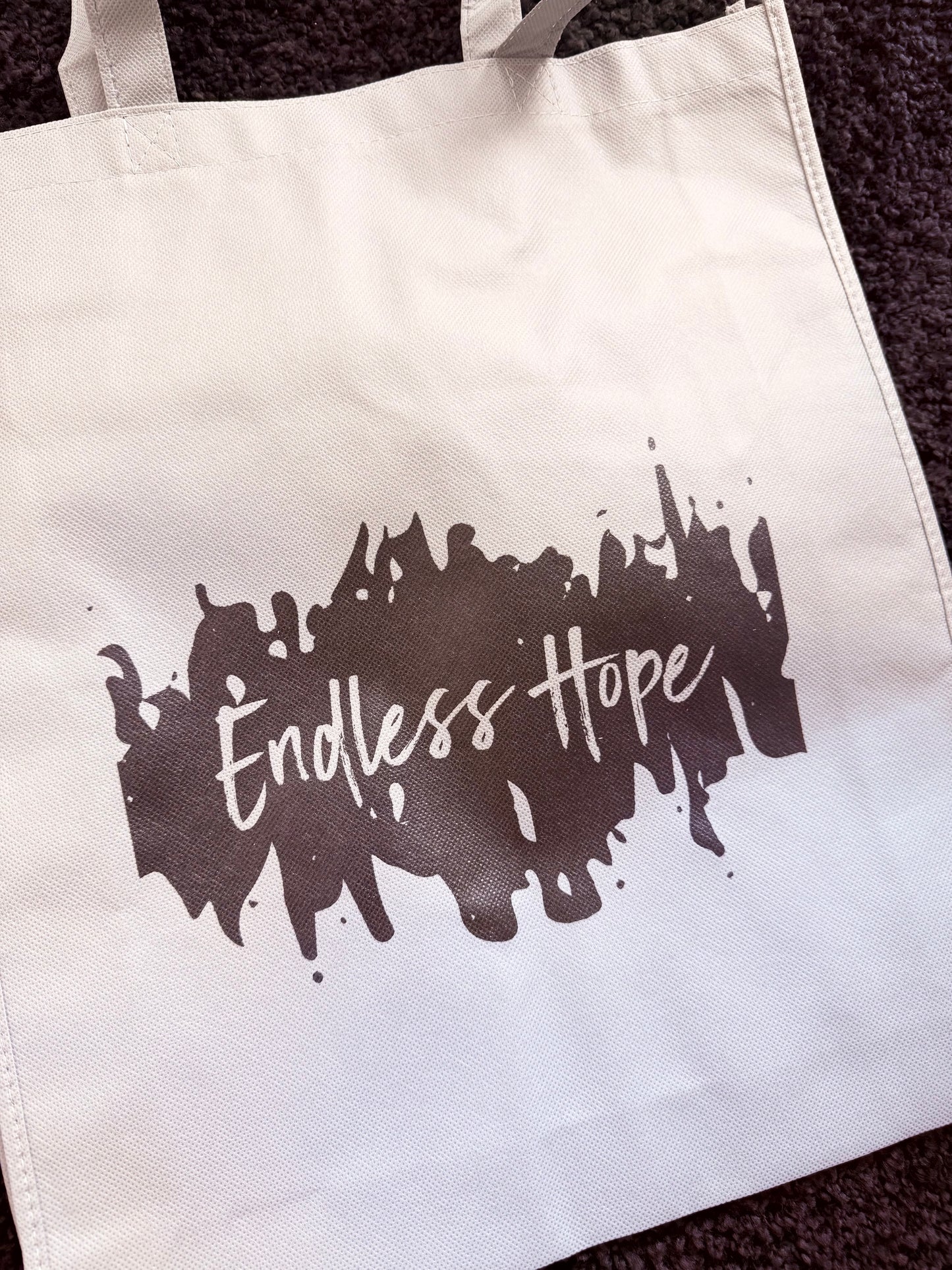 Eco friendly grey bag with black endless hope design on the front.