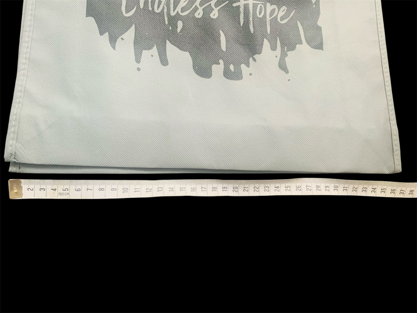 Eco friendly grey bag with black endless hope design on the front.