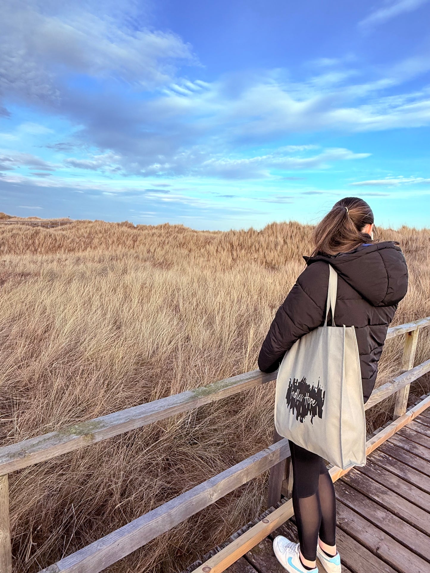 Eco friendly grey bag with black endless hope design on the front.