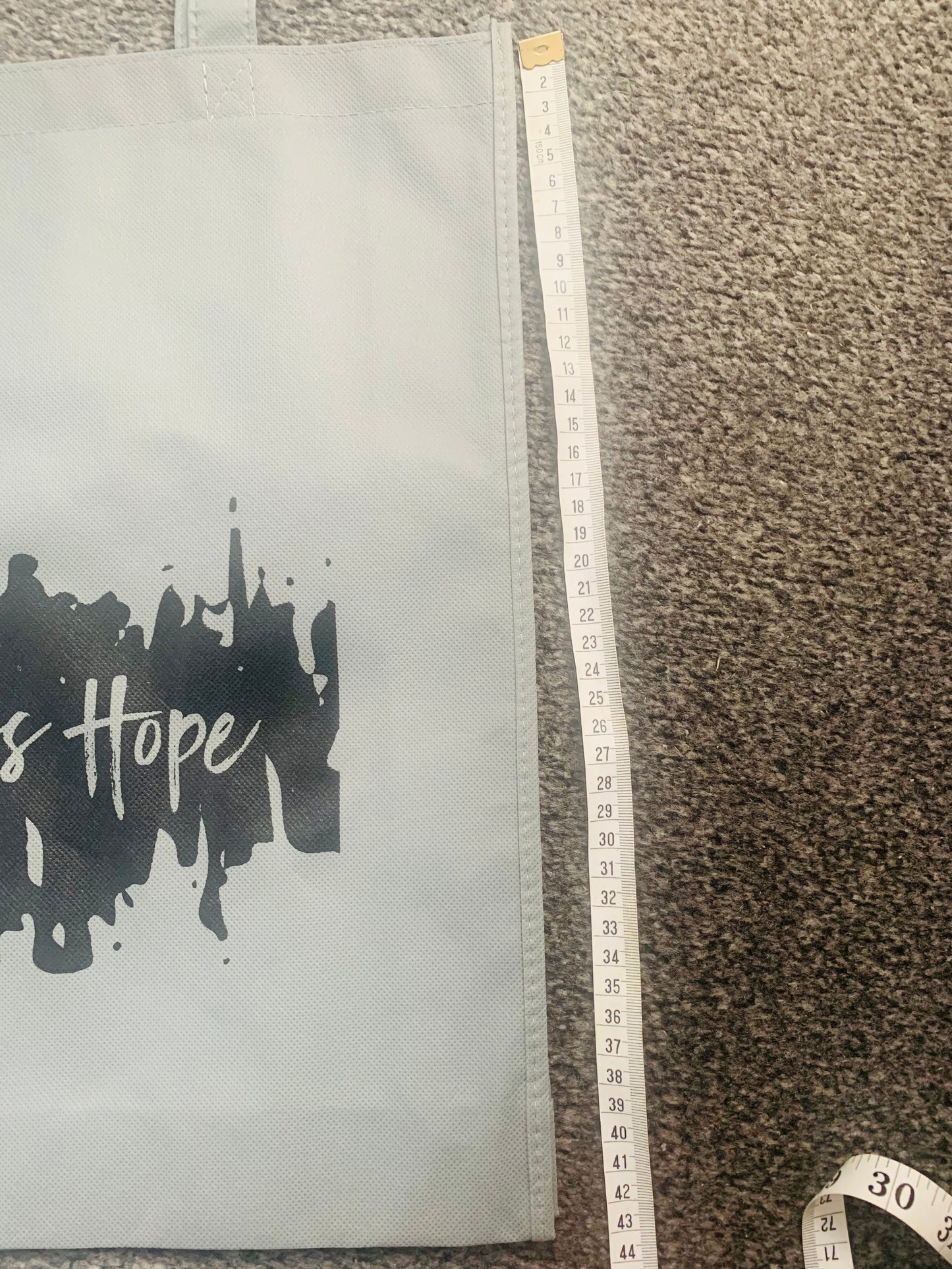 Eco friendly grey bag with black endless hope design on the front.